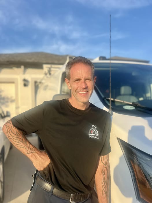 Derek Germain, owner of DG HVAC, standing in front of his service van